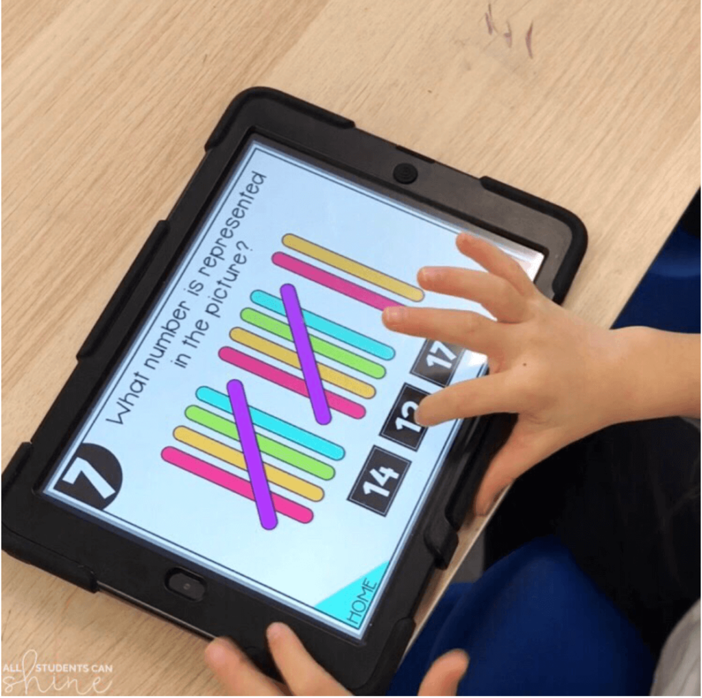 Student uses a tablet to solve a digital number recognition problem by counting colorful tally marks and selecting the correct answer.