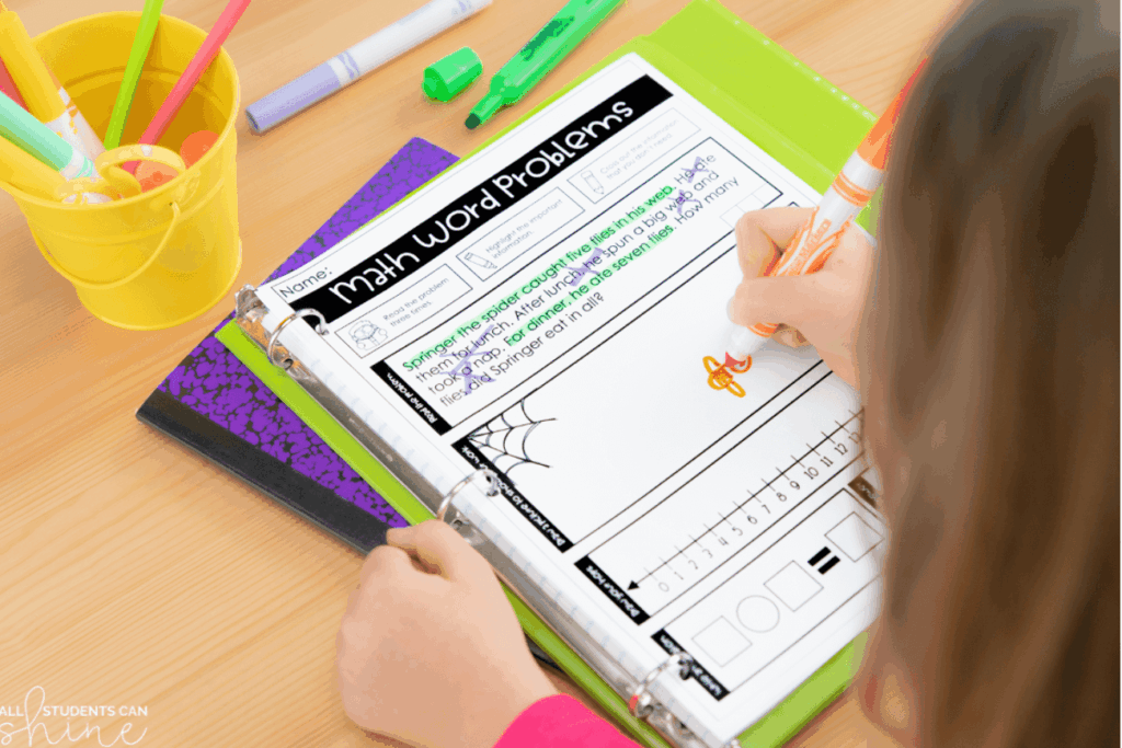 student working on math story problems worksheet in binder with markers and school supplies