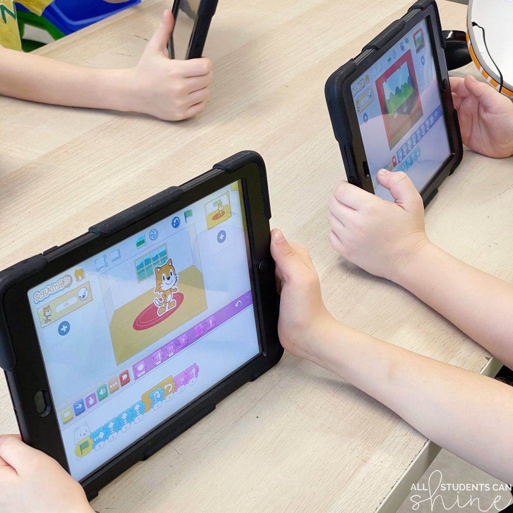 students using tablets with coding apps for kids to create animations and interactive scenes