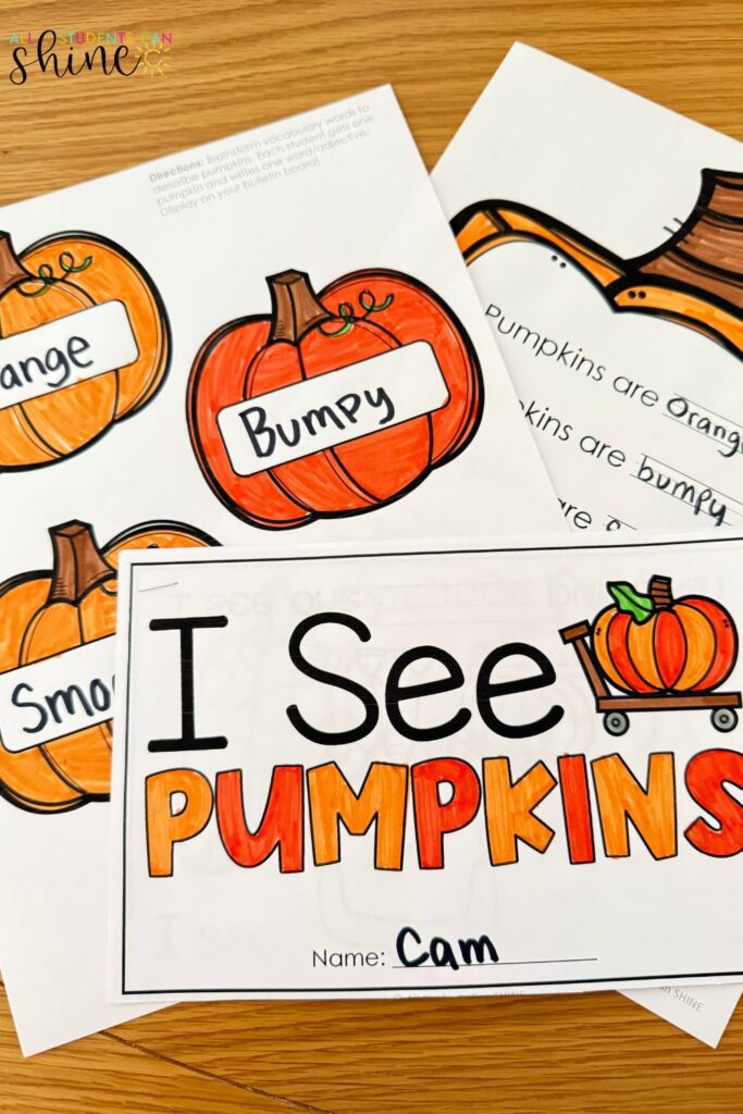 A 2nd-grade student completing a writing activity about pumpkins, describing their characteristics using adjectives like "orange" and "bumpy," part of a monthly writing center for fall.